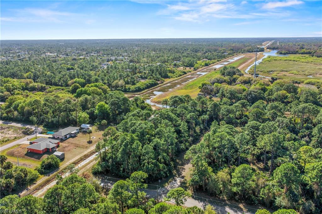 4702 Rita Avenue North Lehigh Acres, FL 33971 - Photo 7 of 15 an aerial view of a city with lots of residential buildings ocean and mountain view in back