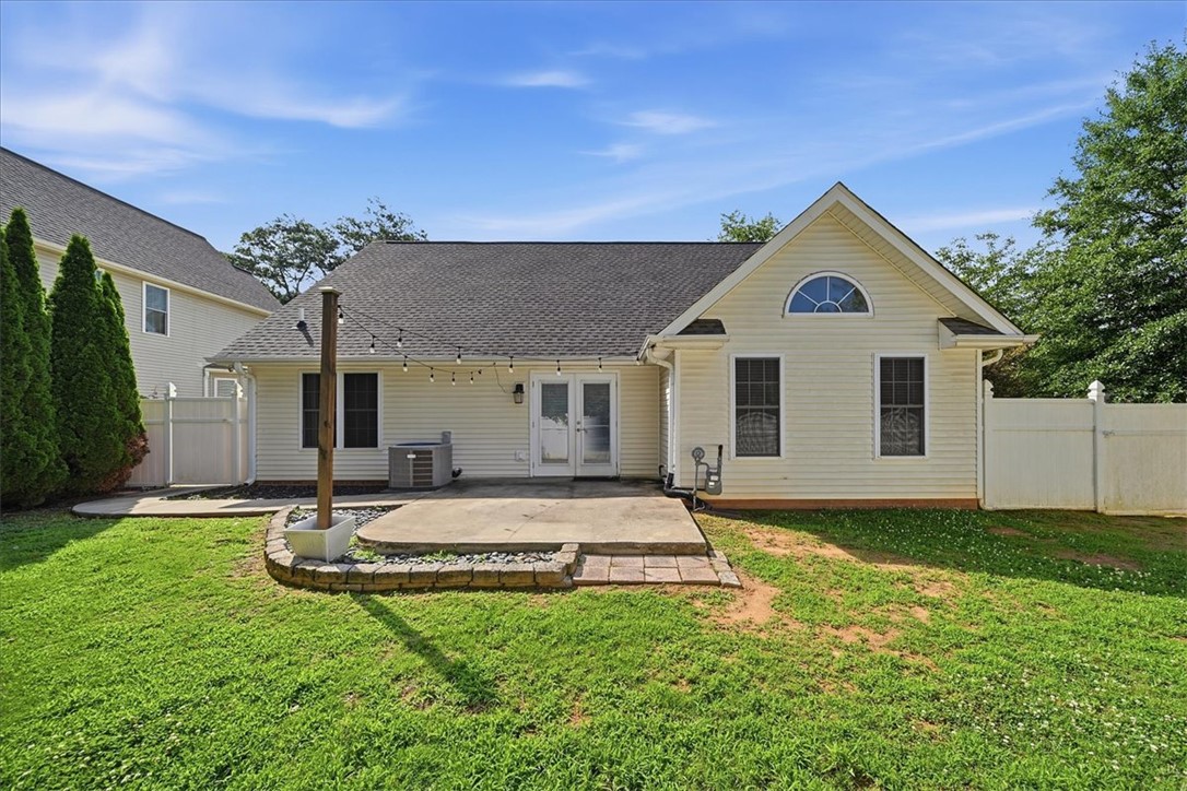 101 Grand Oak Circle Pendleton, SC 29670 - Photo 33 of 40 A neatly maintained backyard features a concrete patio and lush green grass, perfect for outdoor enjoyment.