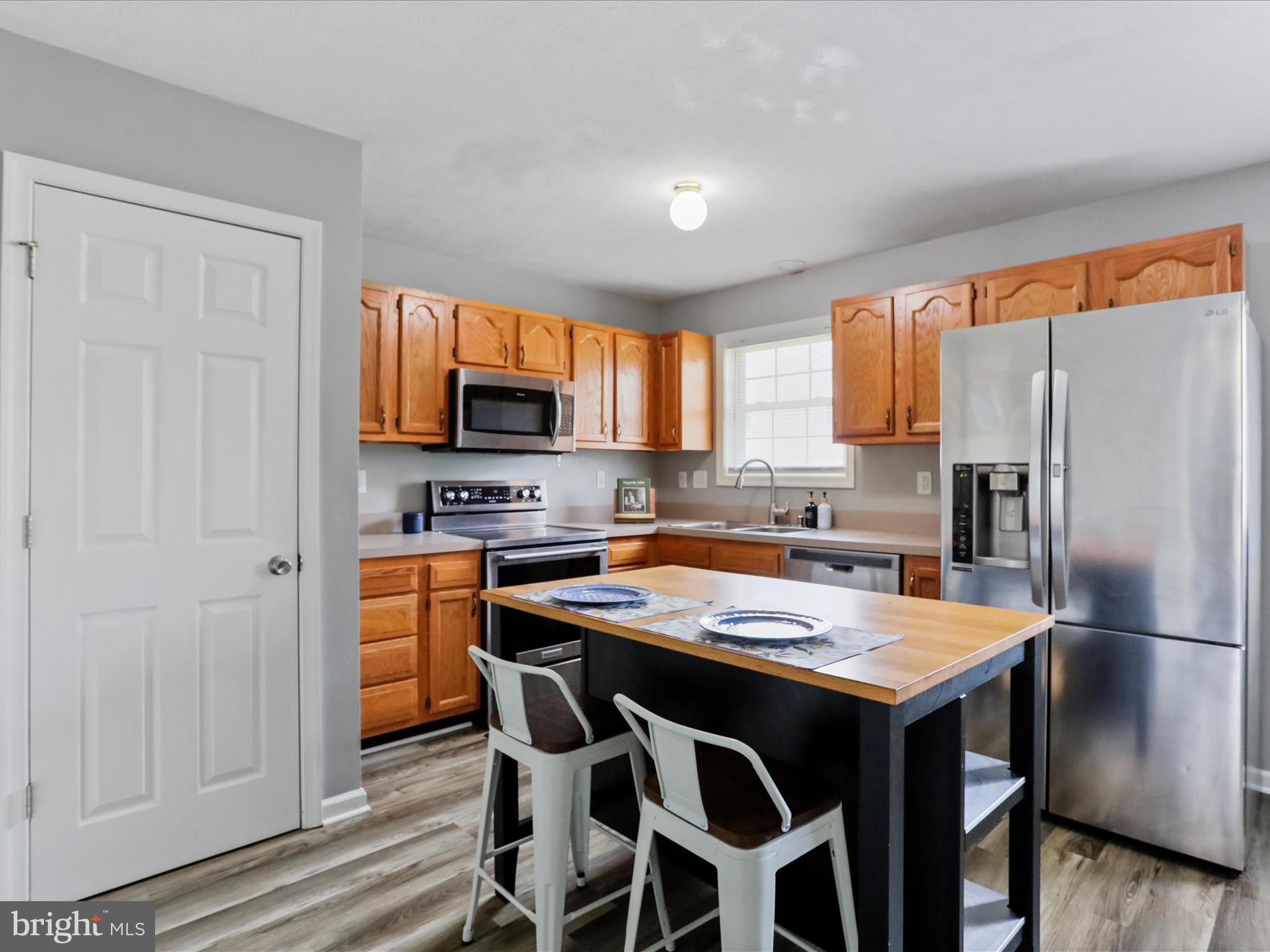 20 Judges Court Inwood, WV 25428 - Photo 8 of 28 Kitchen with island and LVP flooring