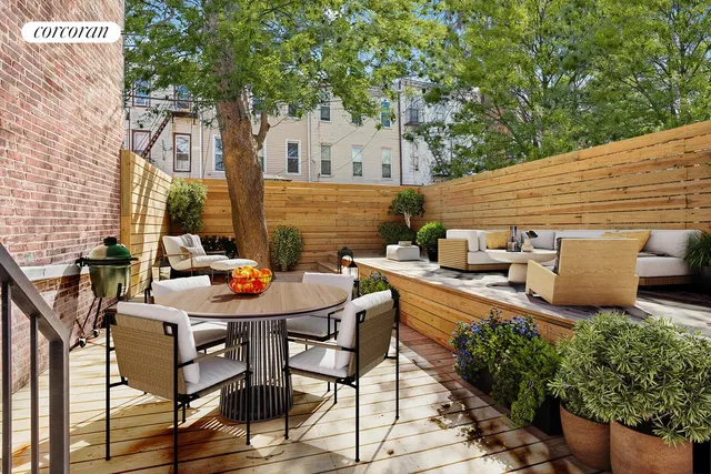 a backyard of a house with table and chairs