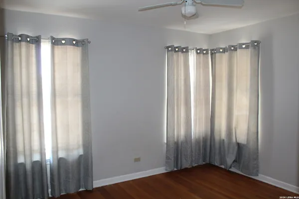 a view of a bathroom with a shower curtain and window
