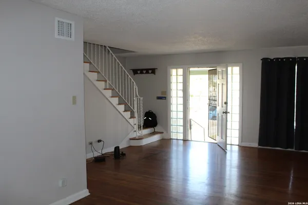 a view of an entryway with wooden floor and stairs