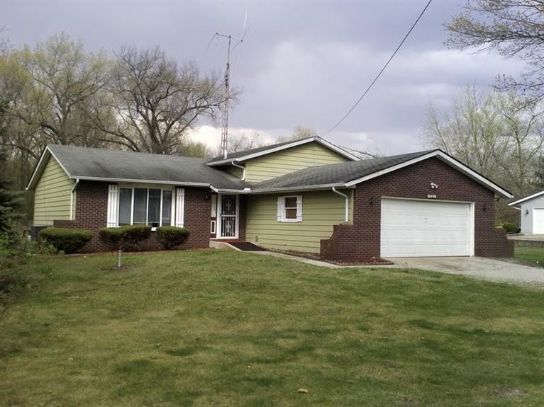 a front view of house with yard and trees