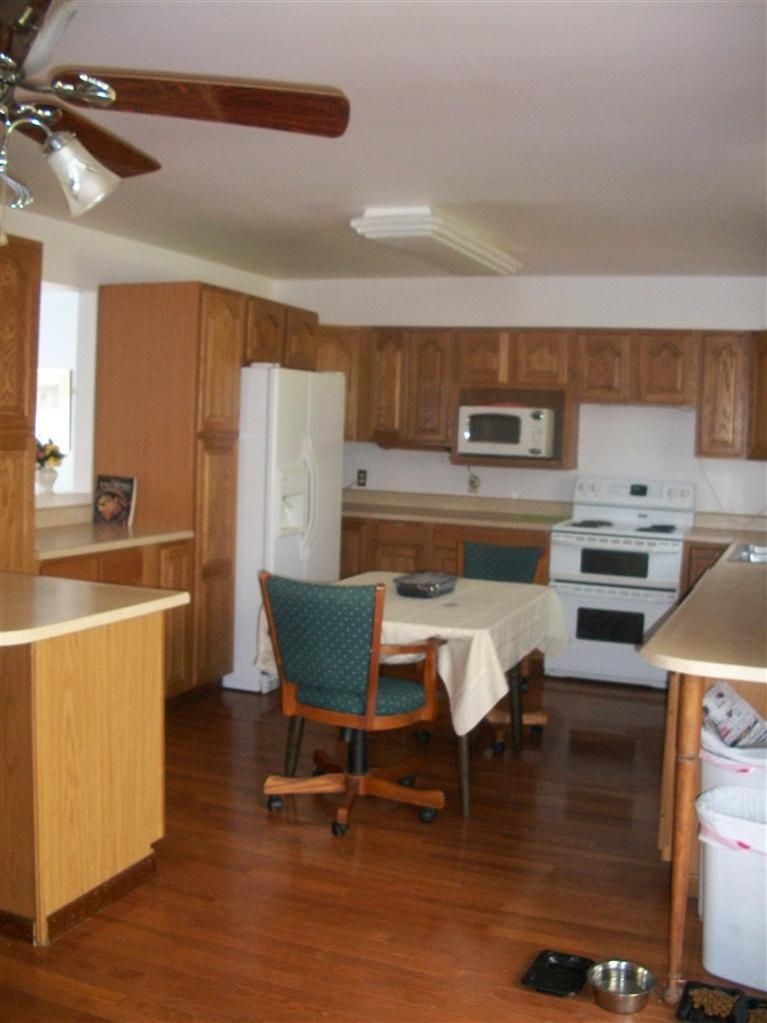 11474 Chateau Lane Demotte, IN 46310 - Photo 5 of 10 a kitchen with a table chairs and a refrigerator