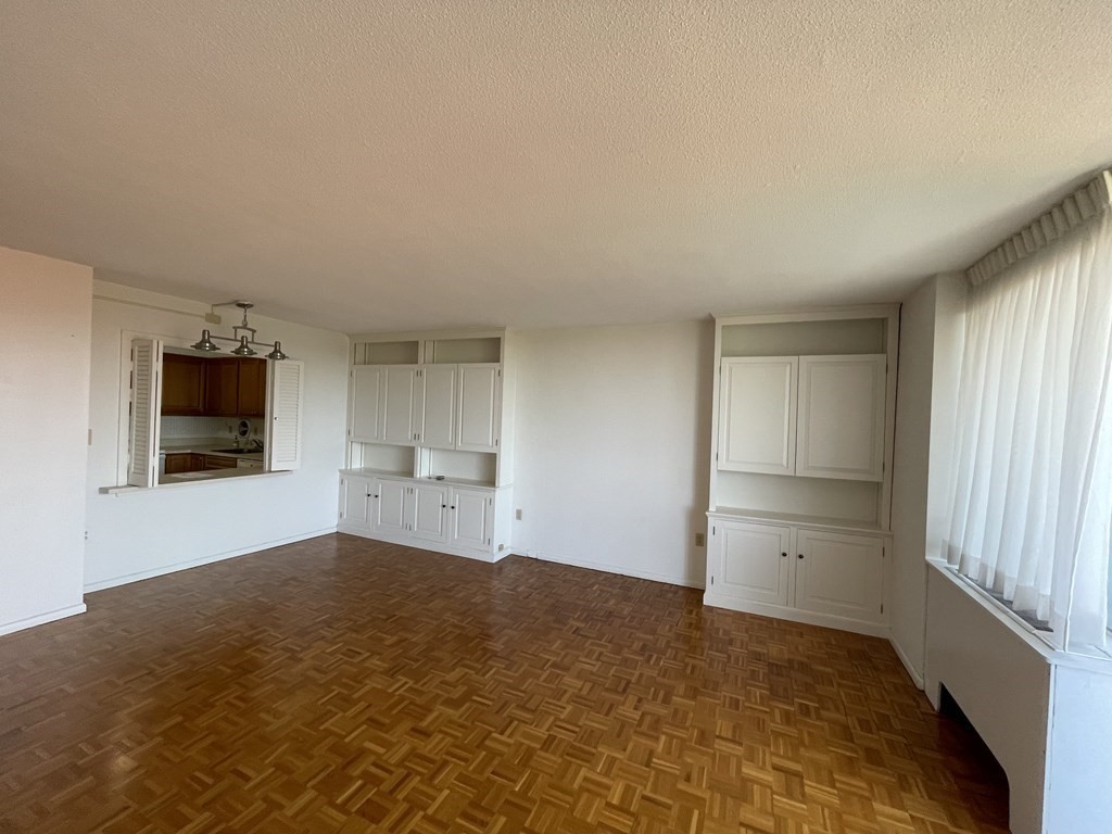 80 Salisbury Street, Unit 806 Worcester, MA 01609 - Photo 13 of 13 a view of empty room with a flat screen tv and kitchen view