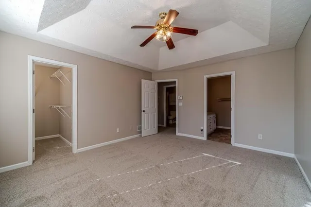 a view of empty room with ceiling fan