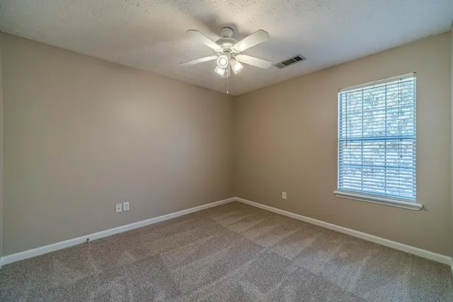 a bathroom with a granite countertop toilet sink and shower