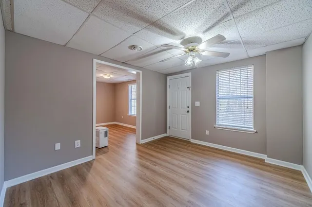 a view of room with window and wooden floor