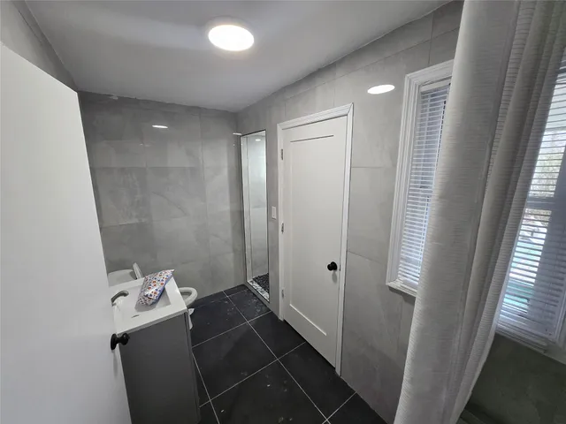a bathroom with a bathtub and shower