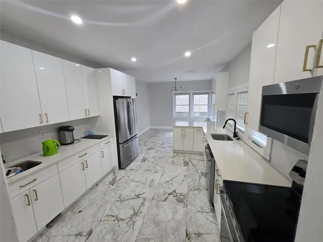 a kitchen with stainless steel appliances a stove sink and cabinets