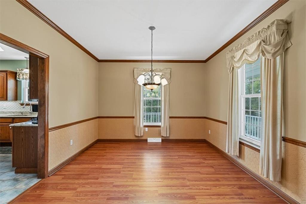 204 Salt Works Road Harmony, PA 16037 - Photo 12 of 35 a view of a hallway with wooden floor and staircase