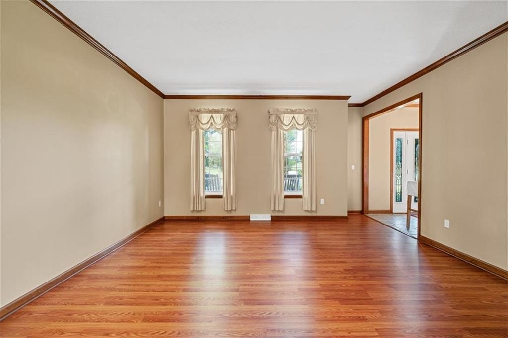 204 Salt Works Road Harmony, PA 16037 - Photo 13 of 35 a view of an empty room with window and wooden floor