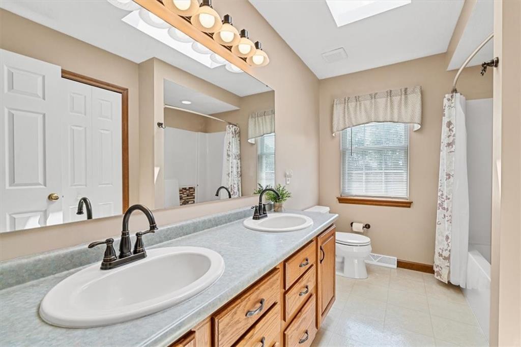 204 Salt Works Road Harmony, PA 16037 - Photo 23 of 35 a bathroom with a double vanity sink and a mirror