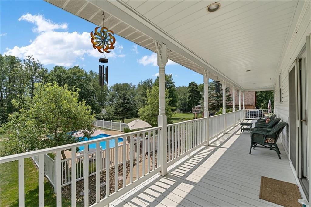 204 Salt Works Road Harmony, PA 16037 - Photo 4 of 35 a view of a balcony with chairs and wooden floor