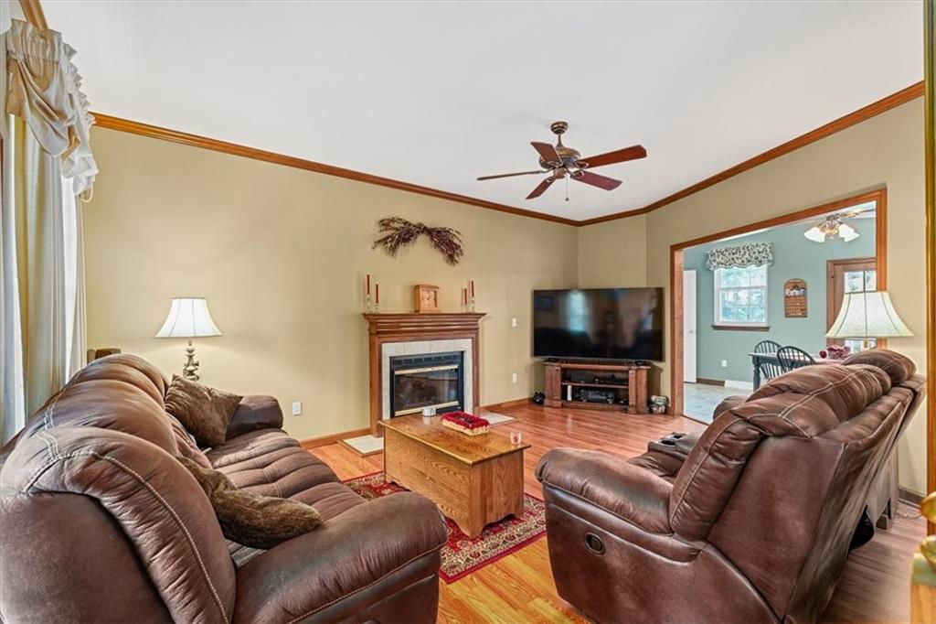 204 Salt Works Road Harmony, PA 16037 - Photo 9 of 35 a living room with furniture a flat screen tv and a fireplace