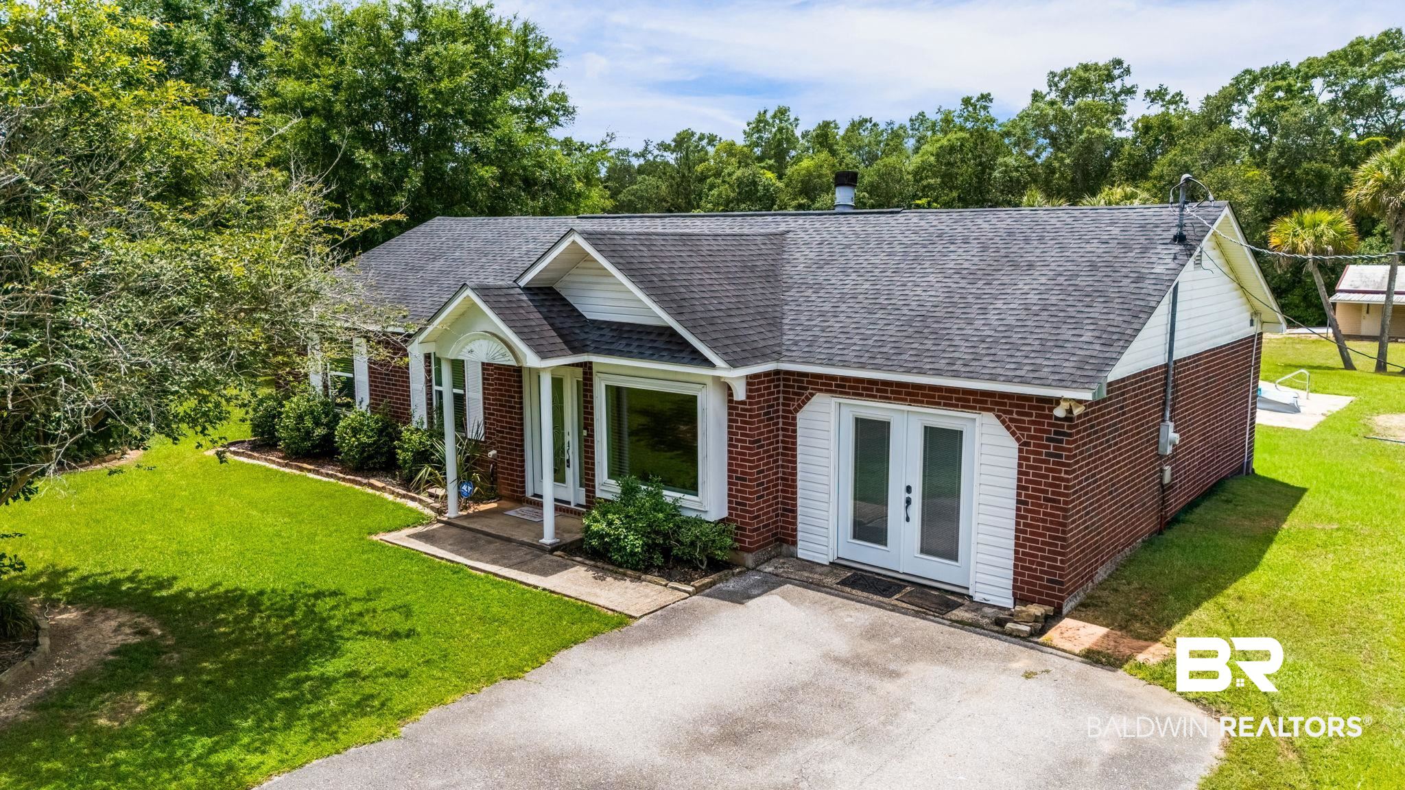 15096 Highland Circle Foley, AL 36535 - Photo 4 of 52 Brick exterior with white siding accents and a gray shingle roof