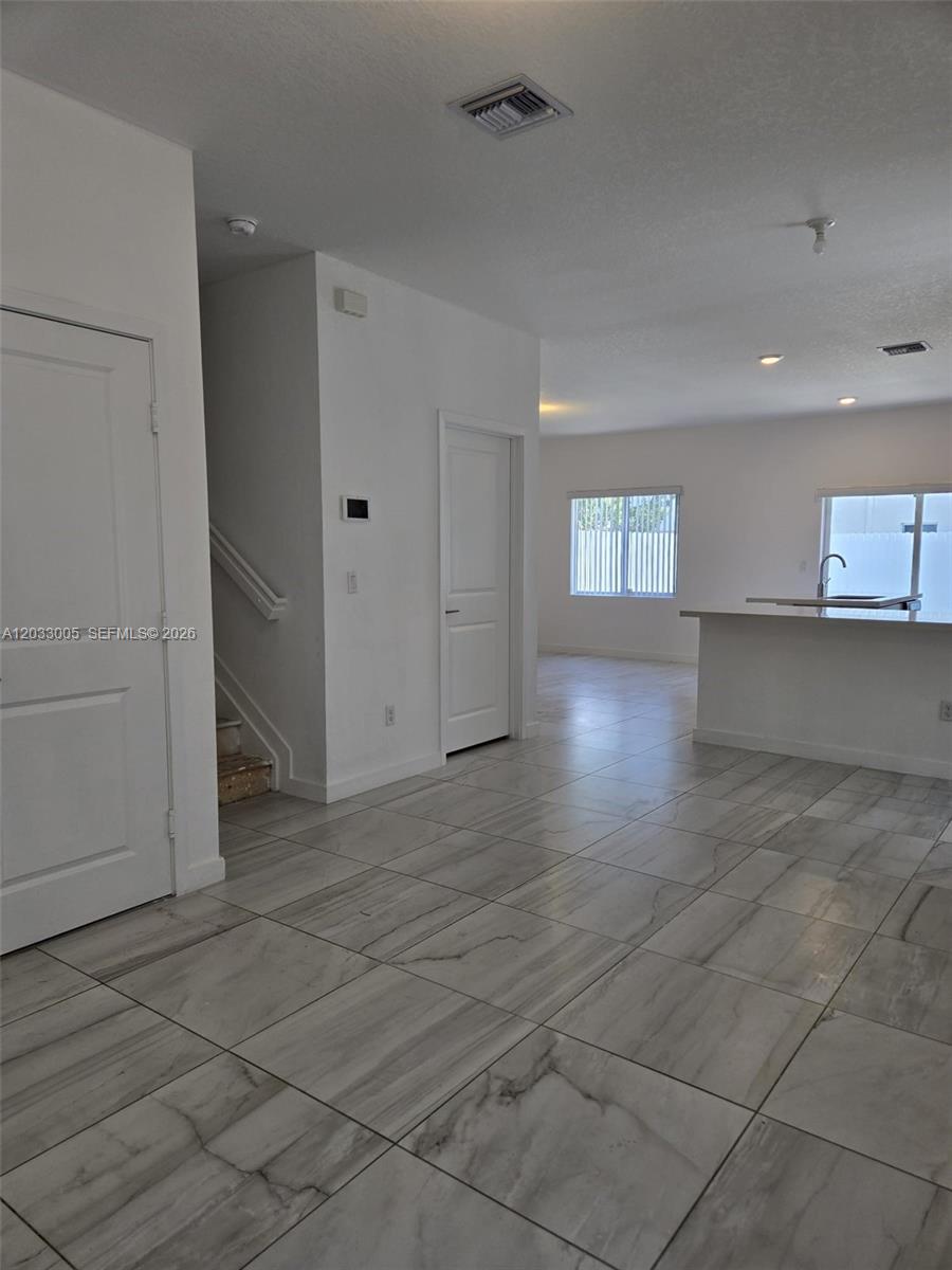 862 Southeast 17 Street, Unit 862 Homestead, FL 33034 - Photo 31 of 39 a view of empty room with kitchen and window