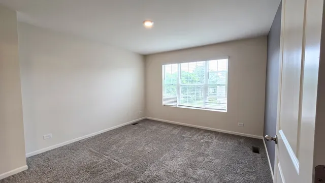 a bathroom with a shower sink vanity mirror and toilet