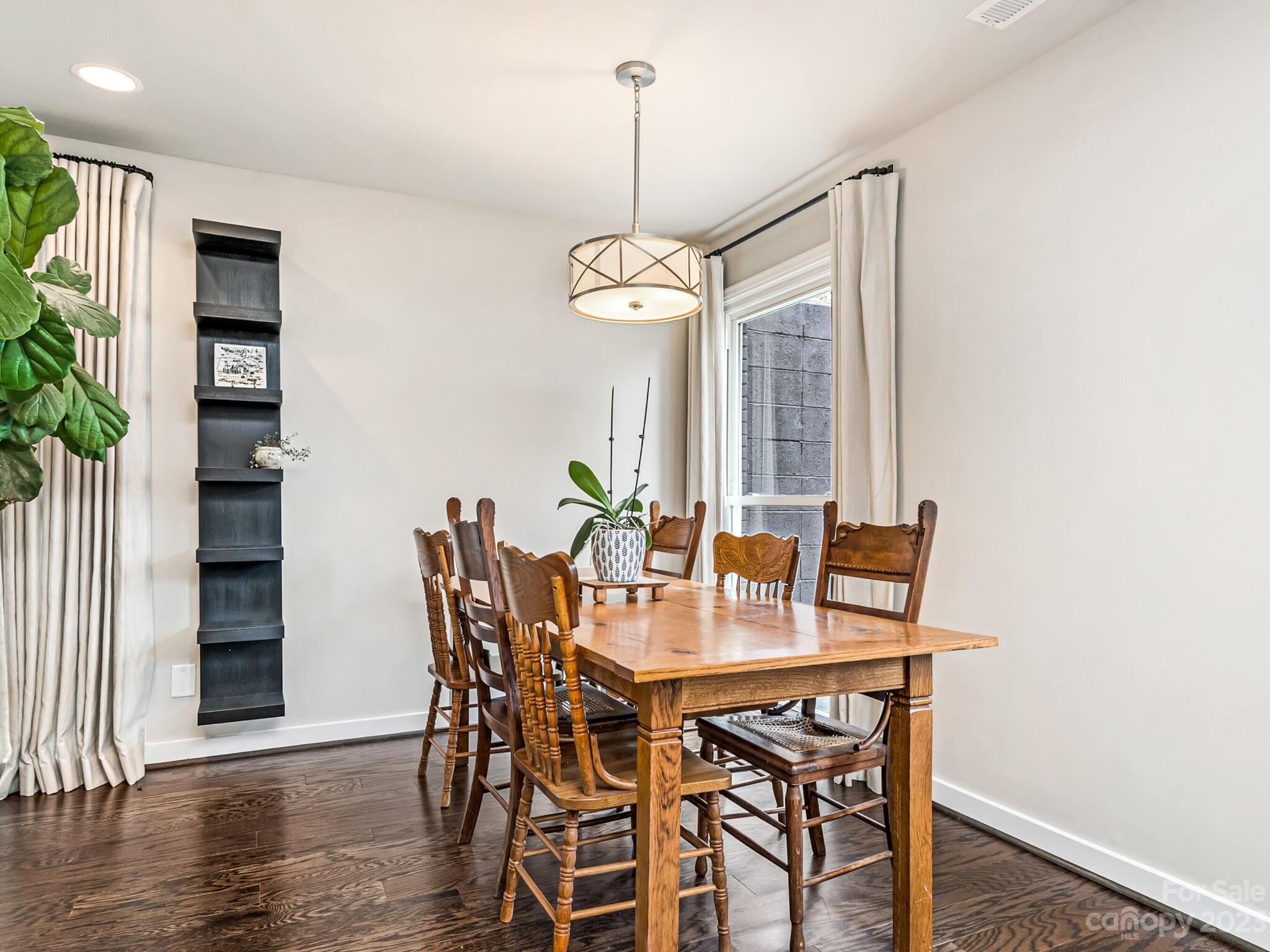 4601 Murrayhill Road Charlotte, NC 28209 - Photo 5 of 21 a view of a dining room with furniture window and wooden floor