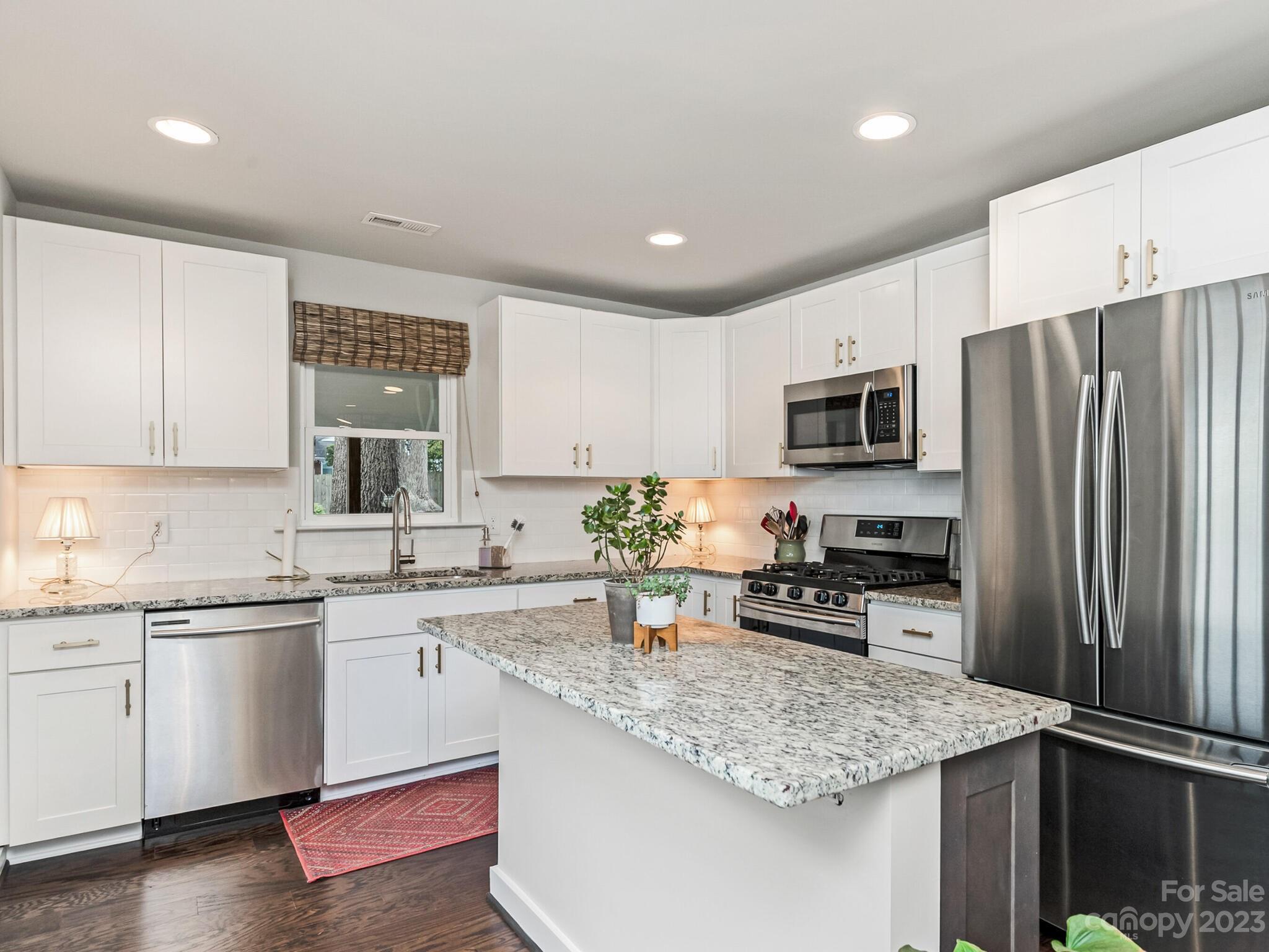 4601 Murrayhill Road Charlotte, NC 28209 - Photo 6 of 21 a kitchen with stainless steel appliances granite countertop a sink stove microwave and refrigerator