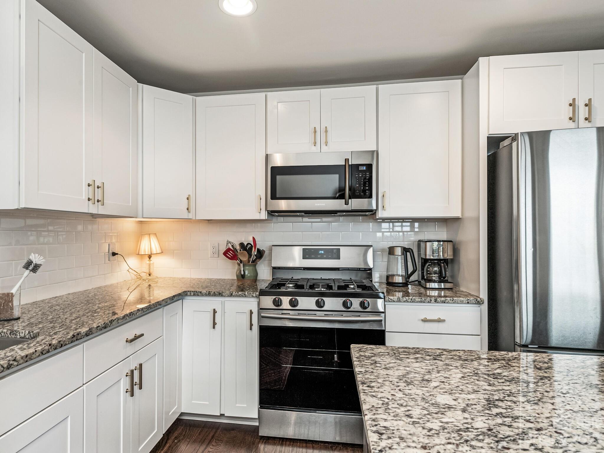 4601 Murrayhill Road Charlotte, NC 28209 - Photo 8 of 21 a kitchen with granite countertop a stove a sink and a refrigerator