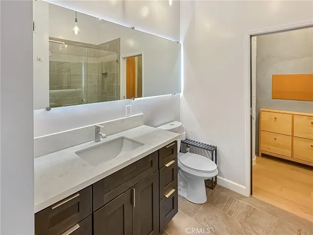 a bathroom with a sink toilet and a mirror