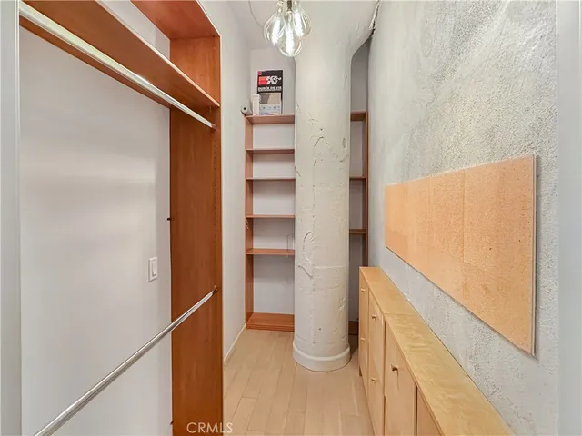 a view of walk in closet with empty racks
