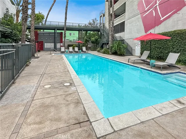 a view of a patio with a table and chairs under an umbrella