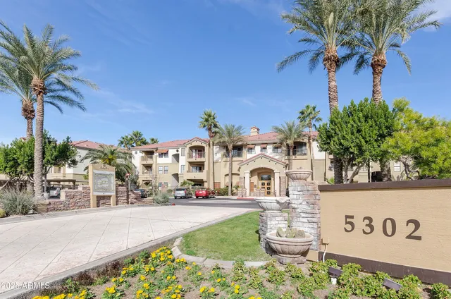 a view of a hallway with entryway wooden floor and front door