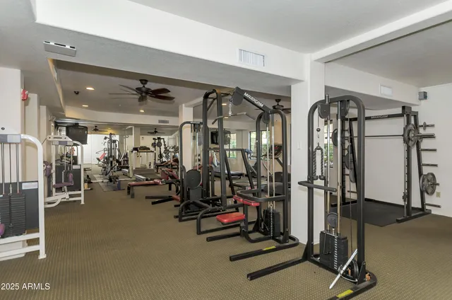 a room with gym equipment and a large window