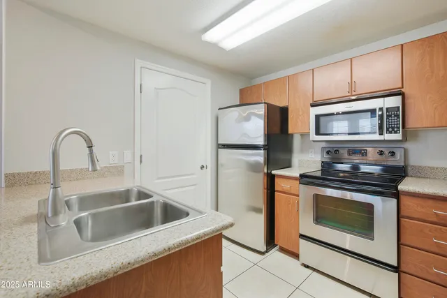 a kitchen with kitchen island a sink appliances and cabinets