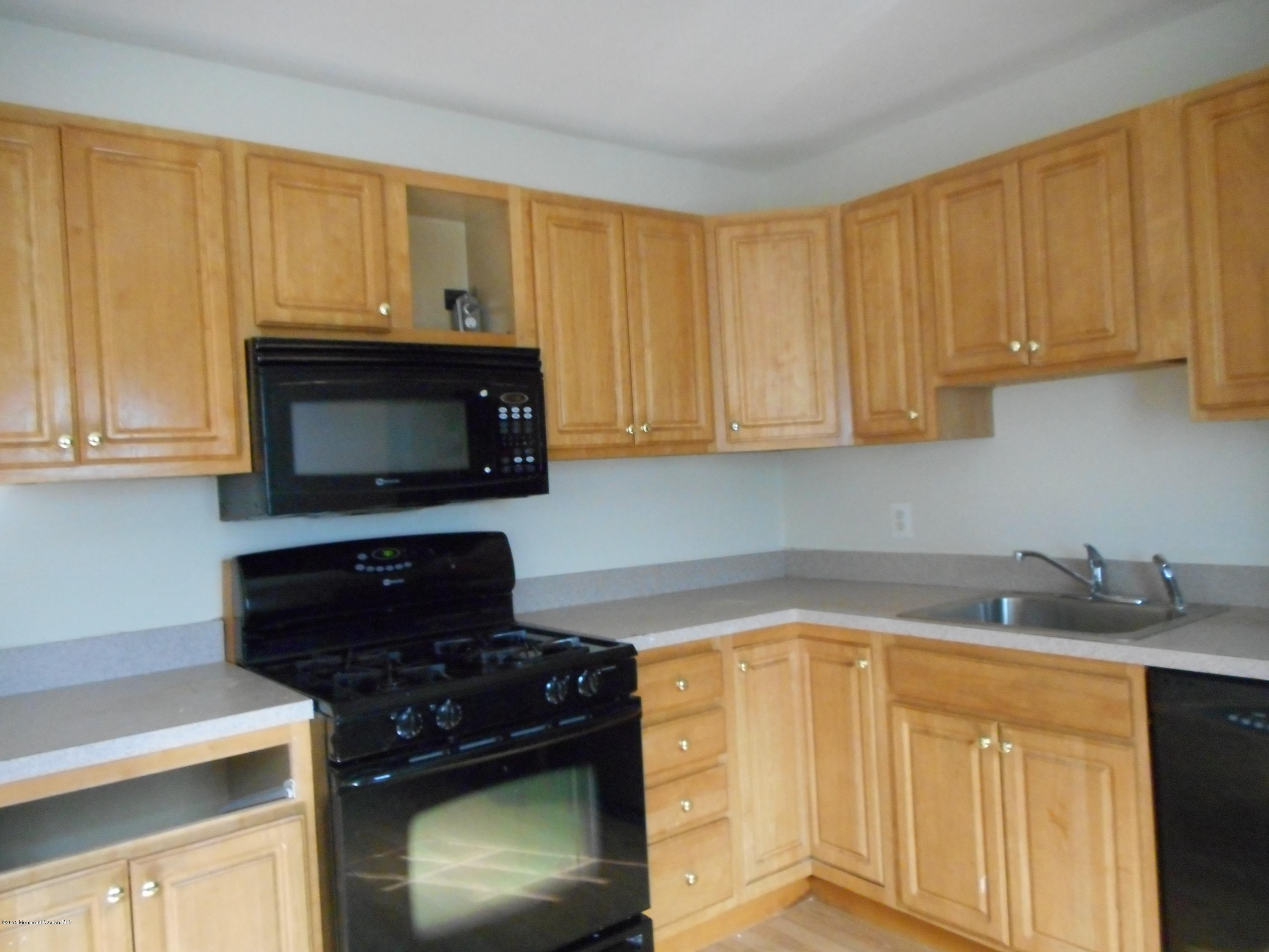 108 Darien Road Howell, NJ 07731 - Photo 14 of 22 a kitchen with stainless steel appliances granite countertop white cabinets and a stove top oven