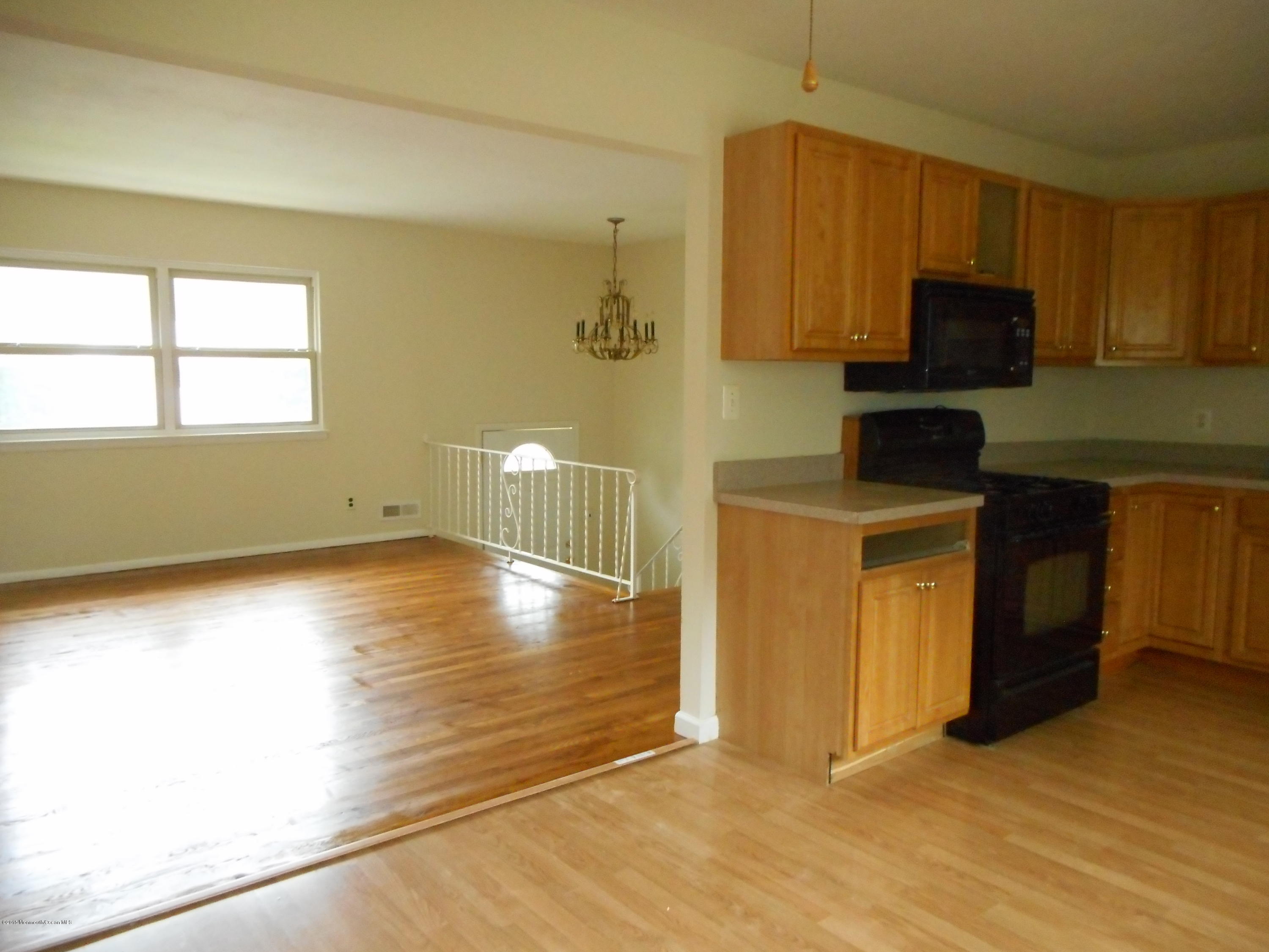 108 Darien Road Howell, NJ 07731 - Photo 16 of 22 a view of a kitchen with wooden floor and a sink
