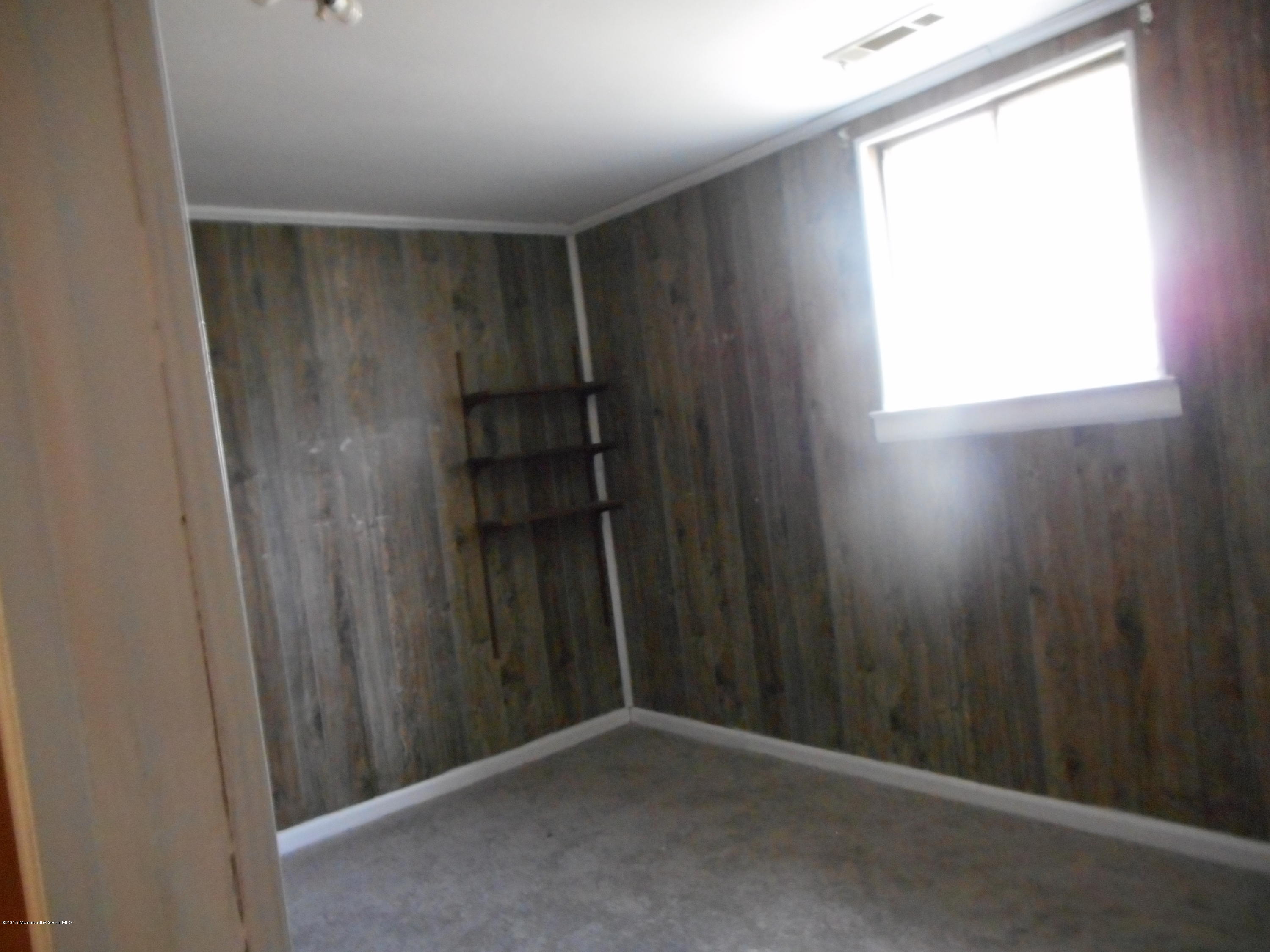 108 Darien Road Howell, NJ 07731 - Photo 3 of 22 a view of an empty room with wooden floor and a window