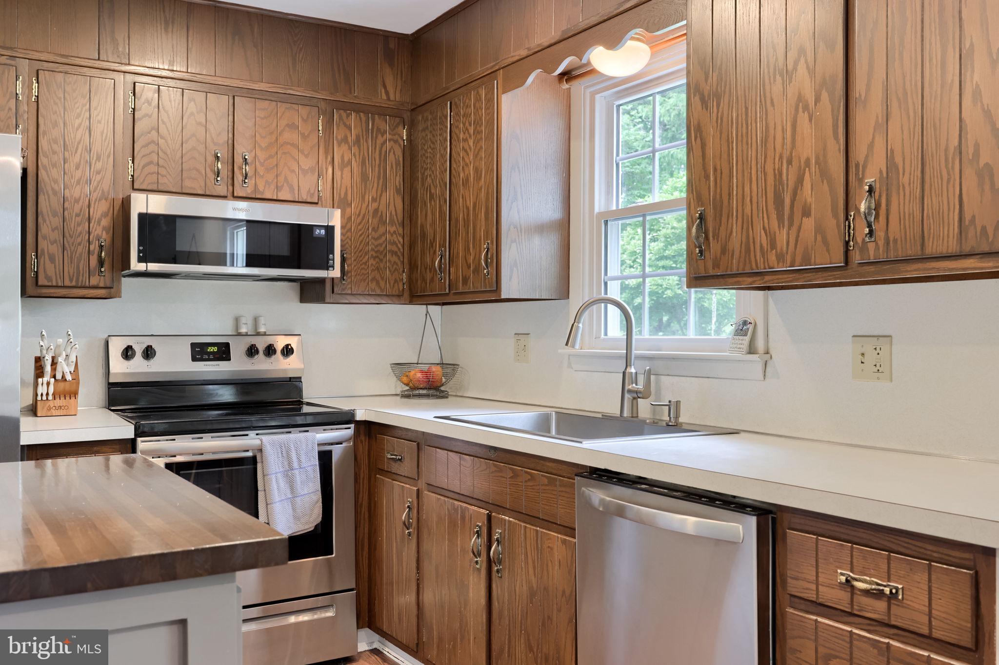 1019 Devonshire Road Lancaster, PA 17601 - Photo 11 of 35 a kitchen with stainless steel appliances a stove sink microwave and cabinets