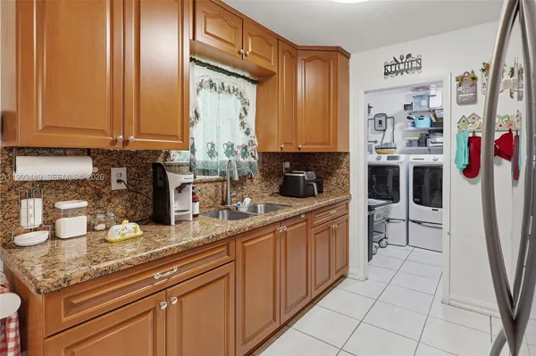 a kitchen with stainless steel appliances granite countertop a sink and cabinets