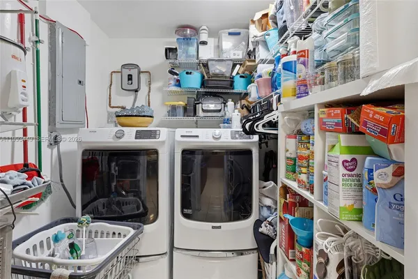 a utility room with microwave and refrigerator