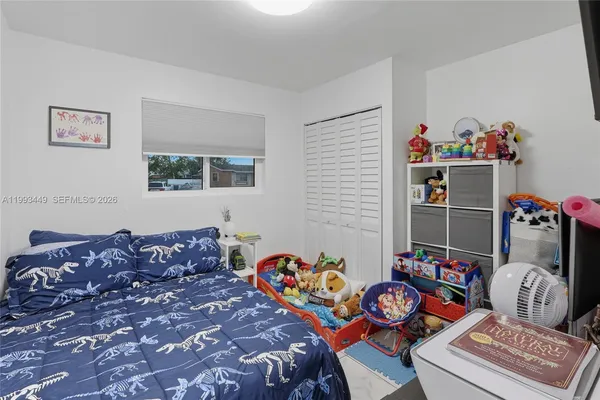 a bedroom with bed and a chandelier