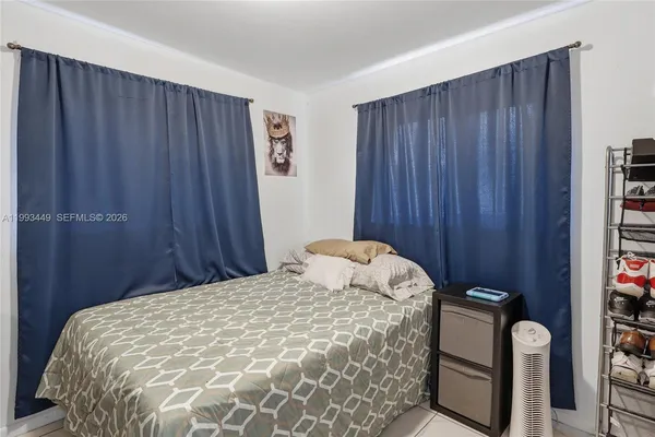 a bed sitting in a bedroom next to a wooden door