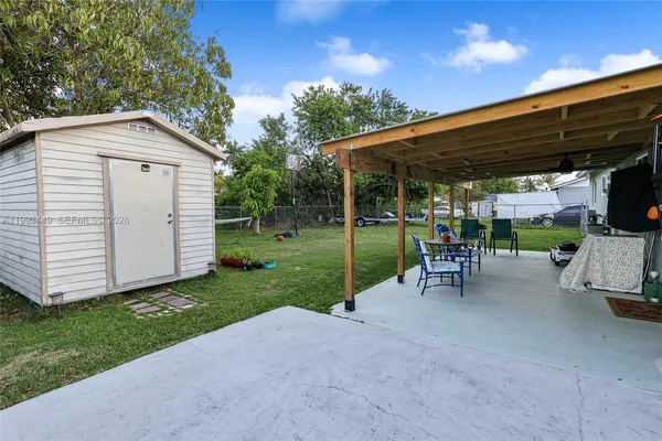 a view of a backyard with a garden and chairs