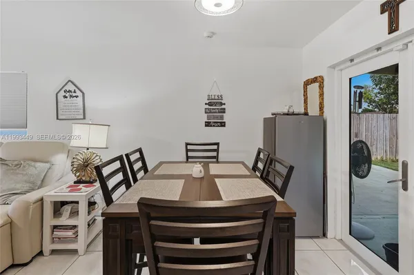 a view of a dining room with furniture and a chandelier