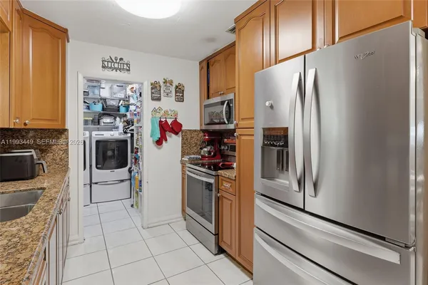 a kitchen with stainless steel appliances a refrigerator and a stove top oven