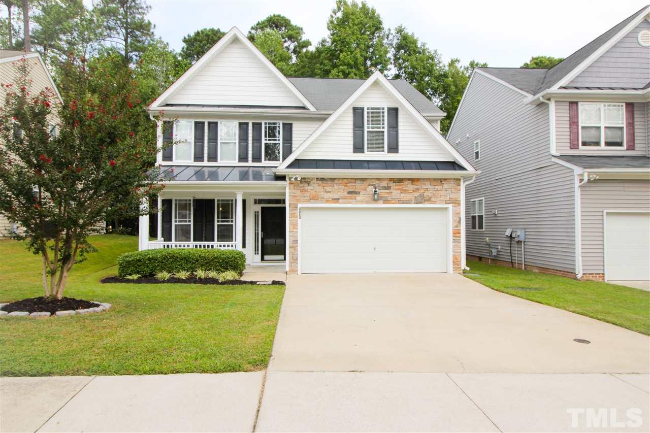 3313 Sunbright Lane Raleigh, NC 27610 - Photo 1 of 25 a front view of a house with a yard and garage
