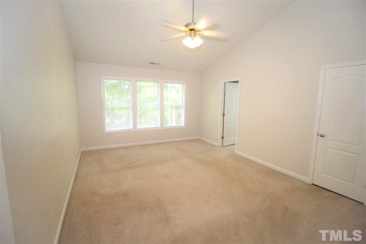 3313 Sunbright Lane Raleigh, NC 27610 - Photo 12 of 25 an empty room with a window and a ceiling fan