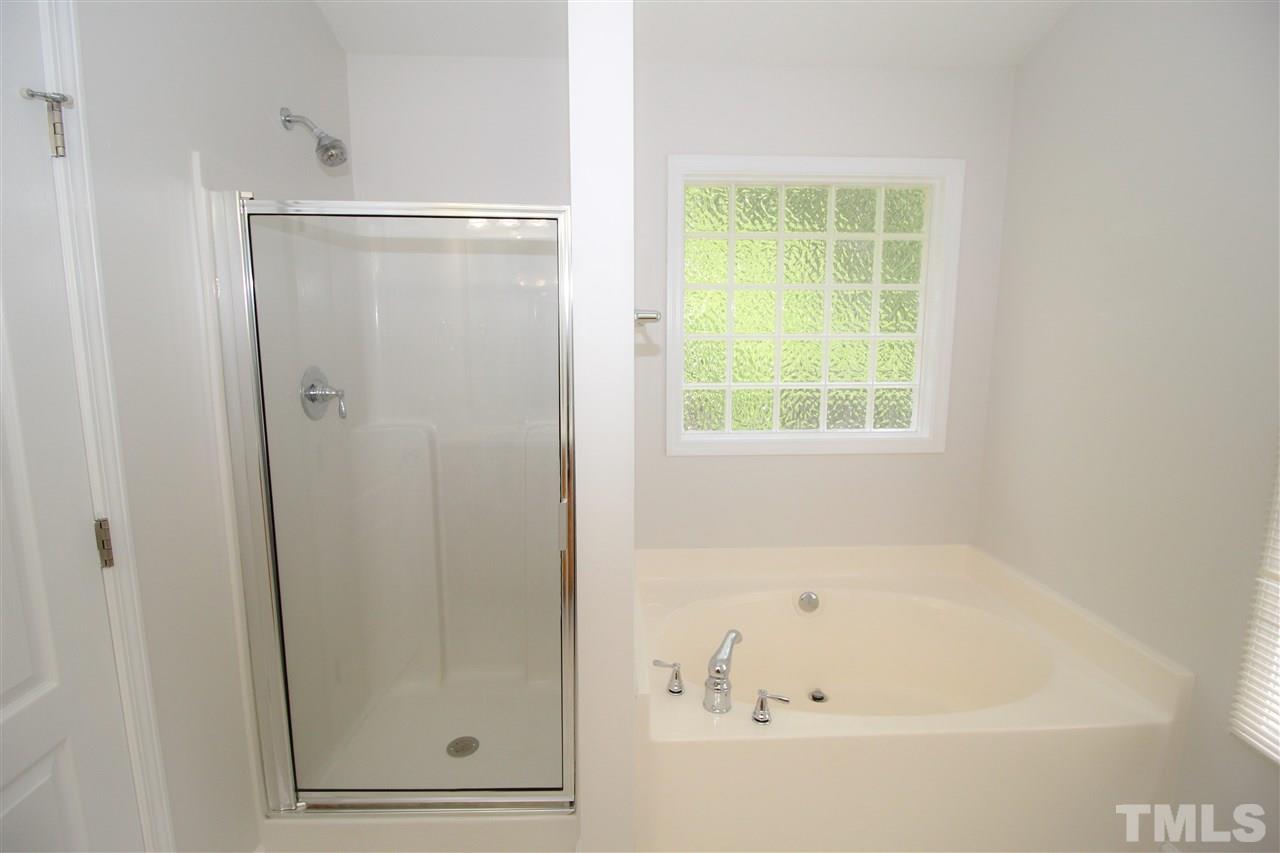 3313 Sunbright Lane Raleigh, NC 27610 - Photo 14 of 25 a bathroom with a bathtub and a shower