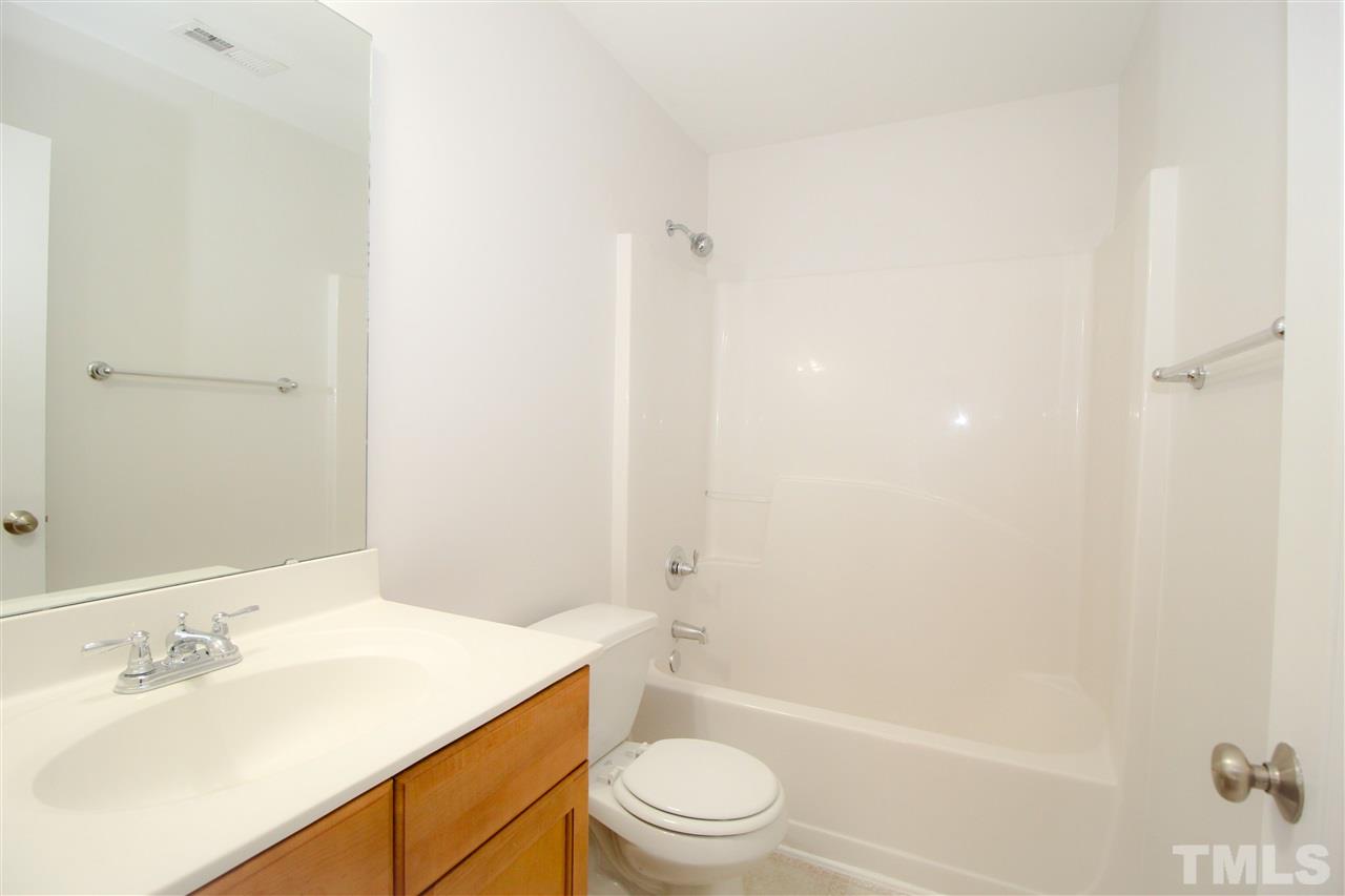 3313 Sunbright Lane Raleigh, NC 27610 - Photo 20 of 25 a bathroom with a sink a toilet and shower