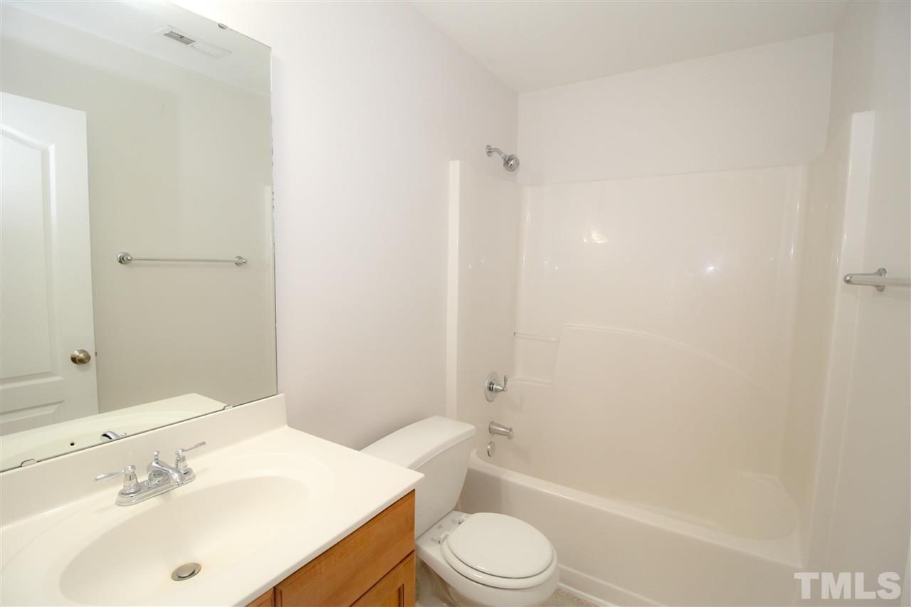 3313 Sunbright Lane Raleigh, NC 27610 - Photo 21 of 25 a bathroom with a sink toilet and shower