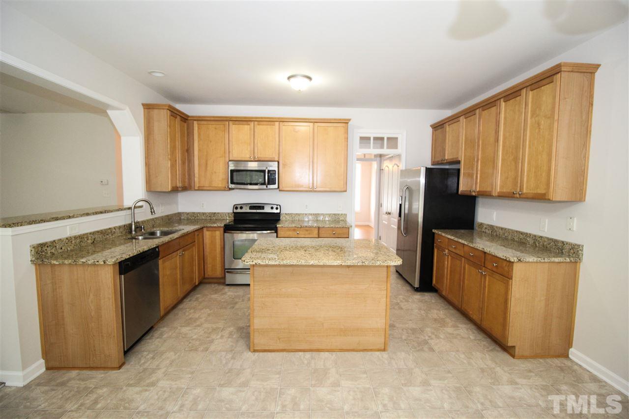 3313 Sunbright Lane Raleigh, NC 27610 - Photo 6 of 25 a large kitchen with stainless steel appliances granite countertop a stove a sink dishwasher and a refrigerator