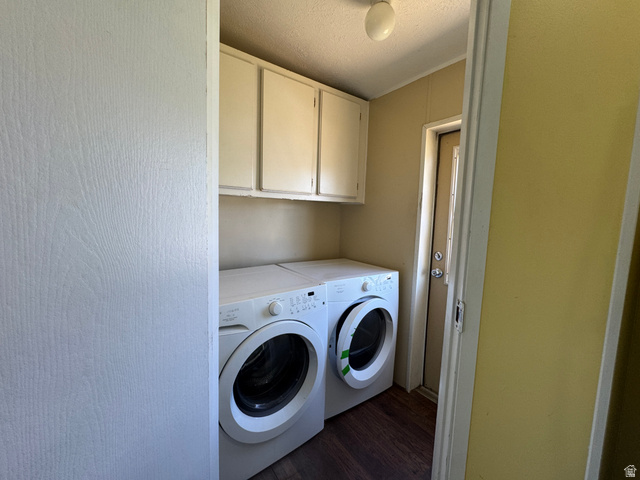 2491 Highway 89, Unit 315 Pleasant View, UT 84404 - Photo 19 of 34 Laundry area featuring wood-finish flooring and upper cabinetry