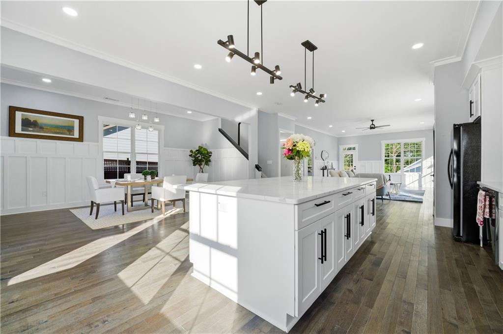 358 St Johns Avenue Southwest Atlanta, GA 30315 - Photo 11 of 35 a kitchen with stainless steel appliances kitchen island granite countertop a large center island and a wooden floor